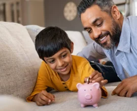 Indian_Father_With_Child_Piggy_Bank_Financial_Advice